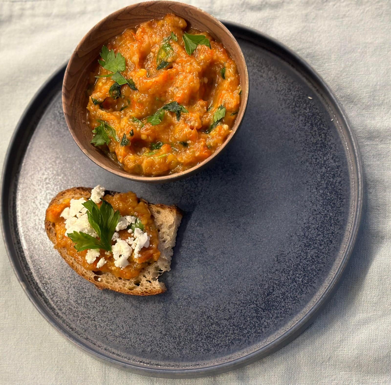 Roasted eggplant spread a plate with food on it Roasted eggplant spread