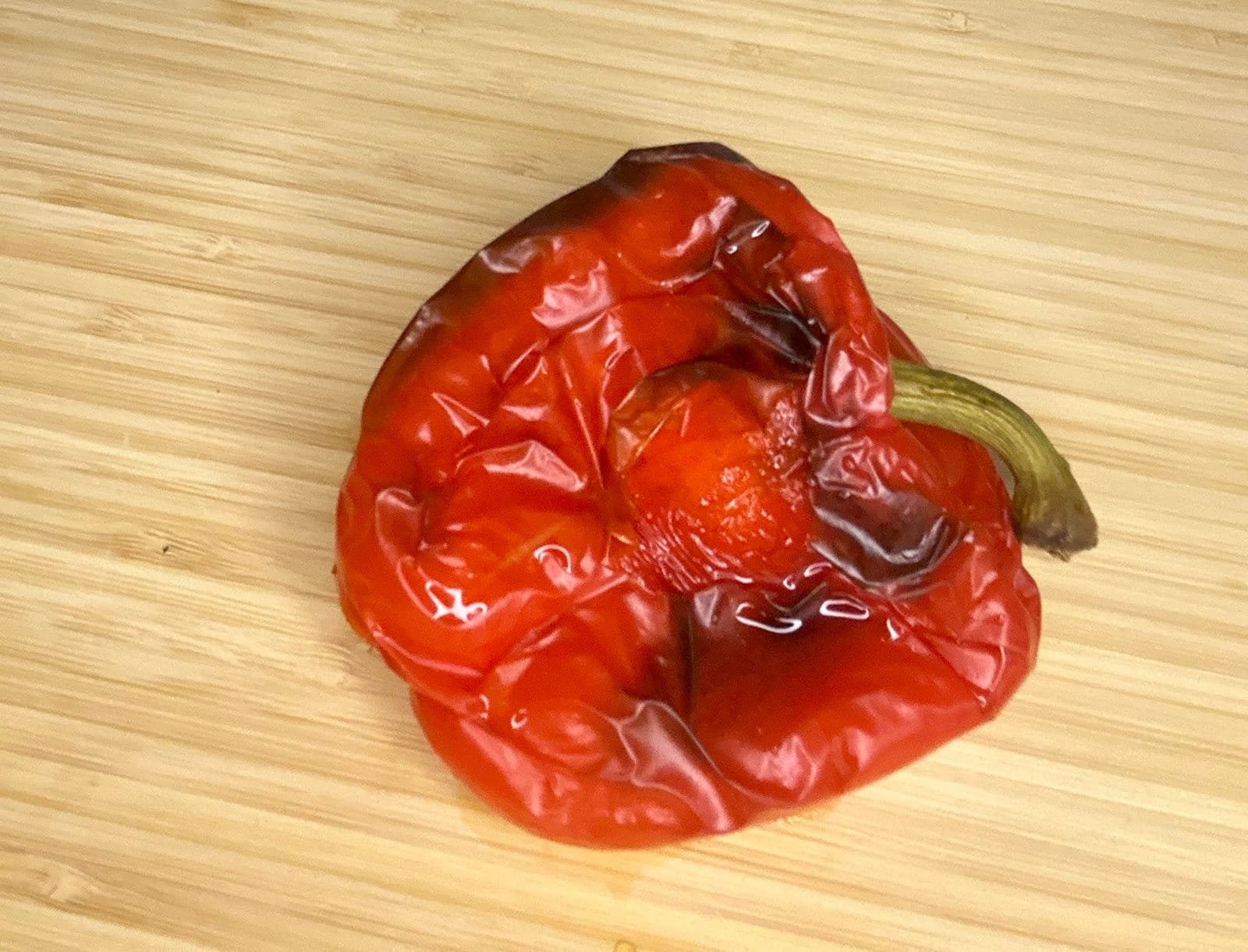 red pepper a red pepper with a burnt stem