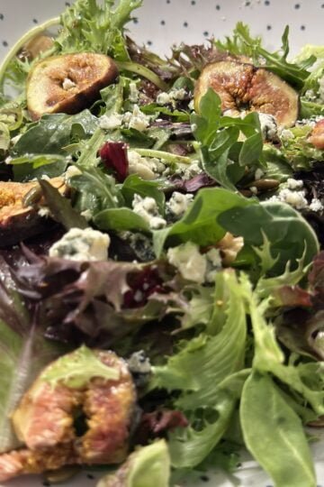 A bowl with figs and blue cheese maple glazed salad