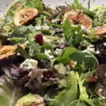 A bowl with figs and blue cheese maple glazed salad