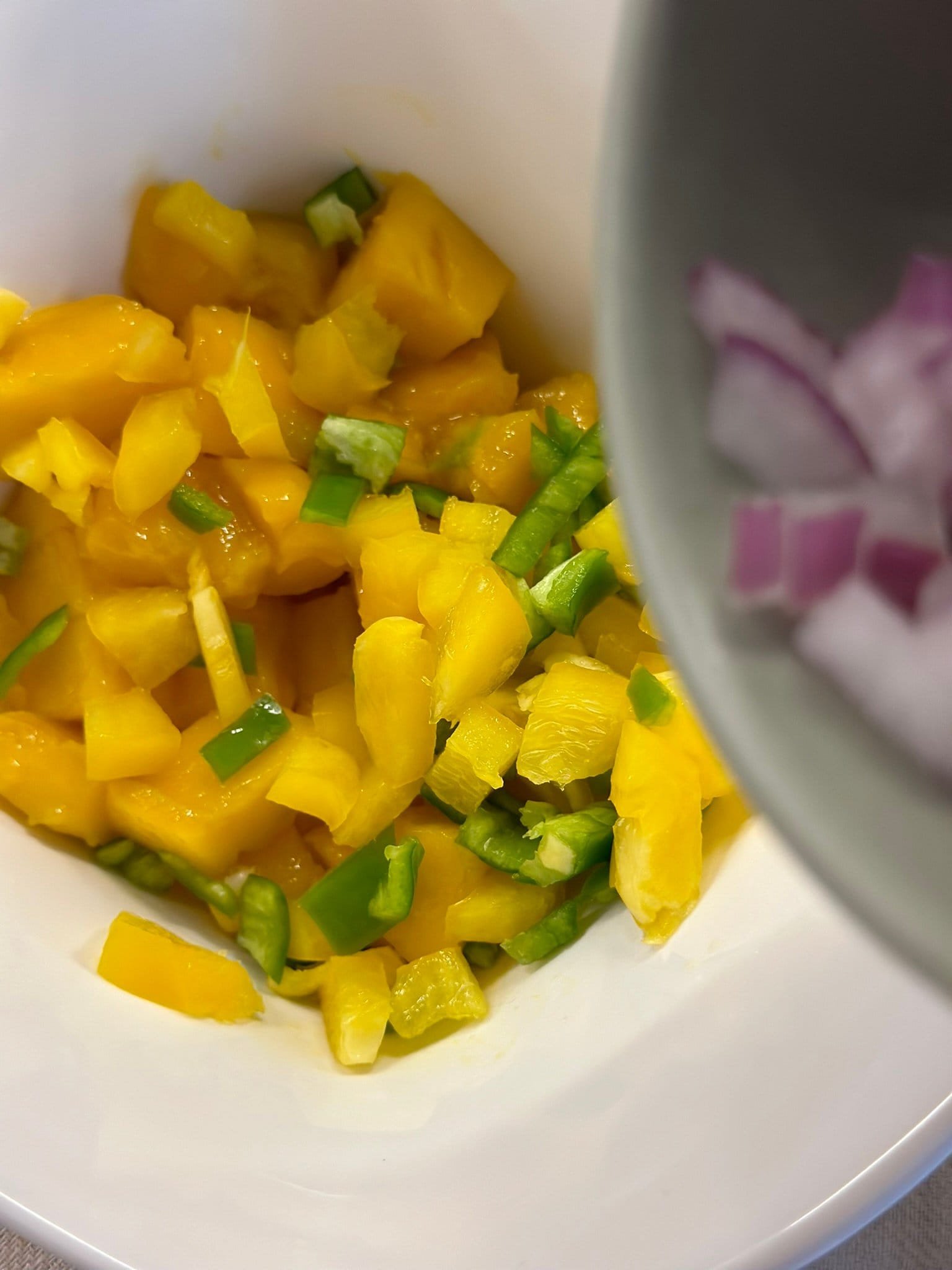 Fiesta Mango Salsa adding onion