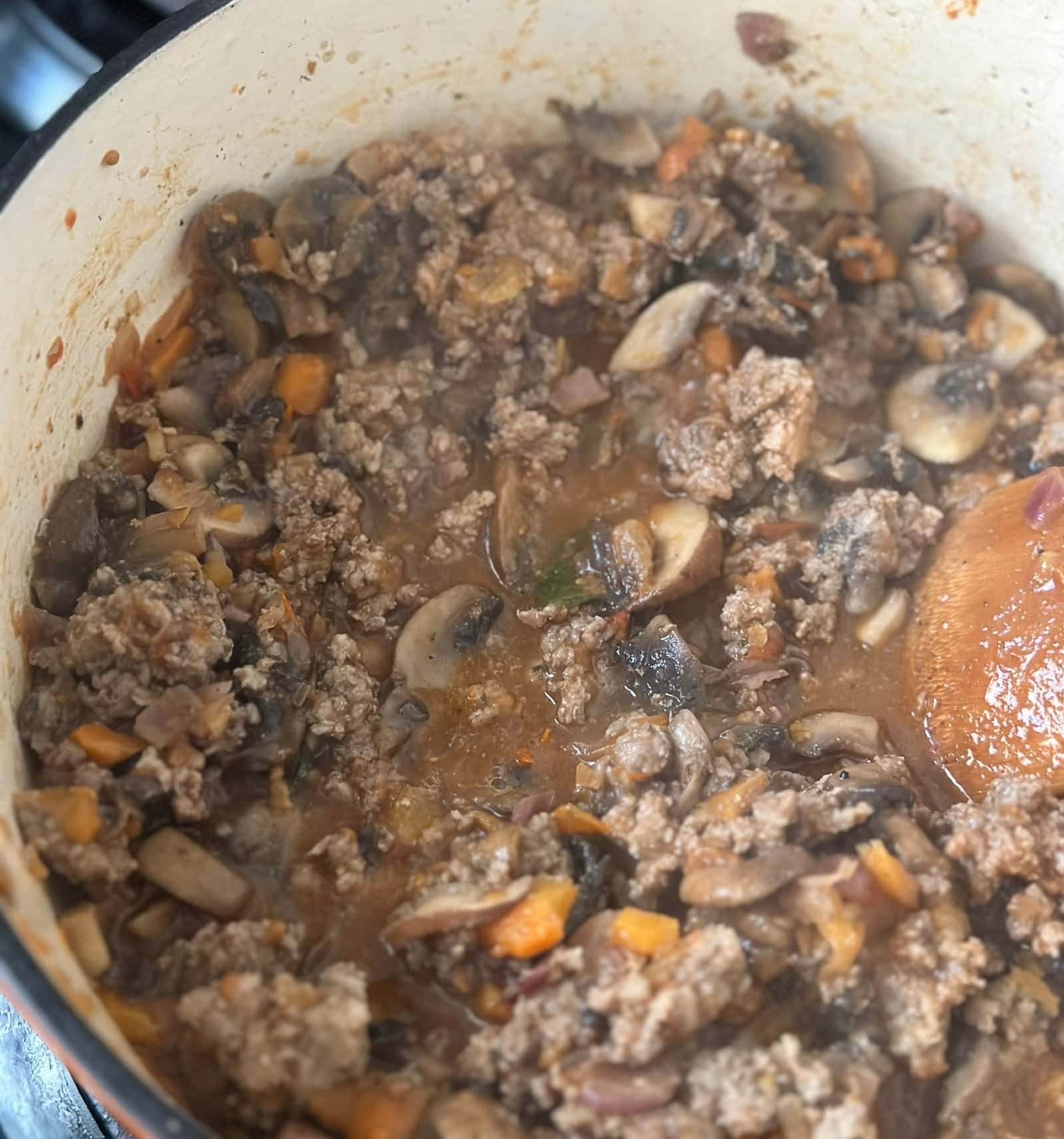 The Best Bolognese Sauce cooking vegetables and meat in a pot