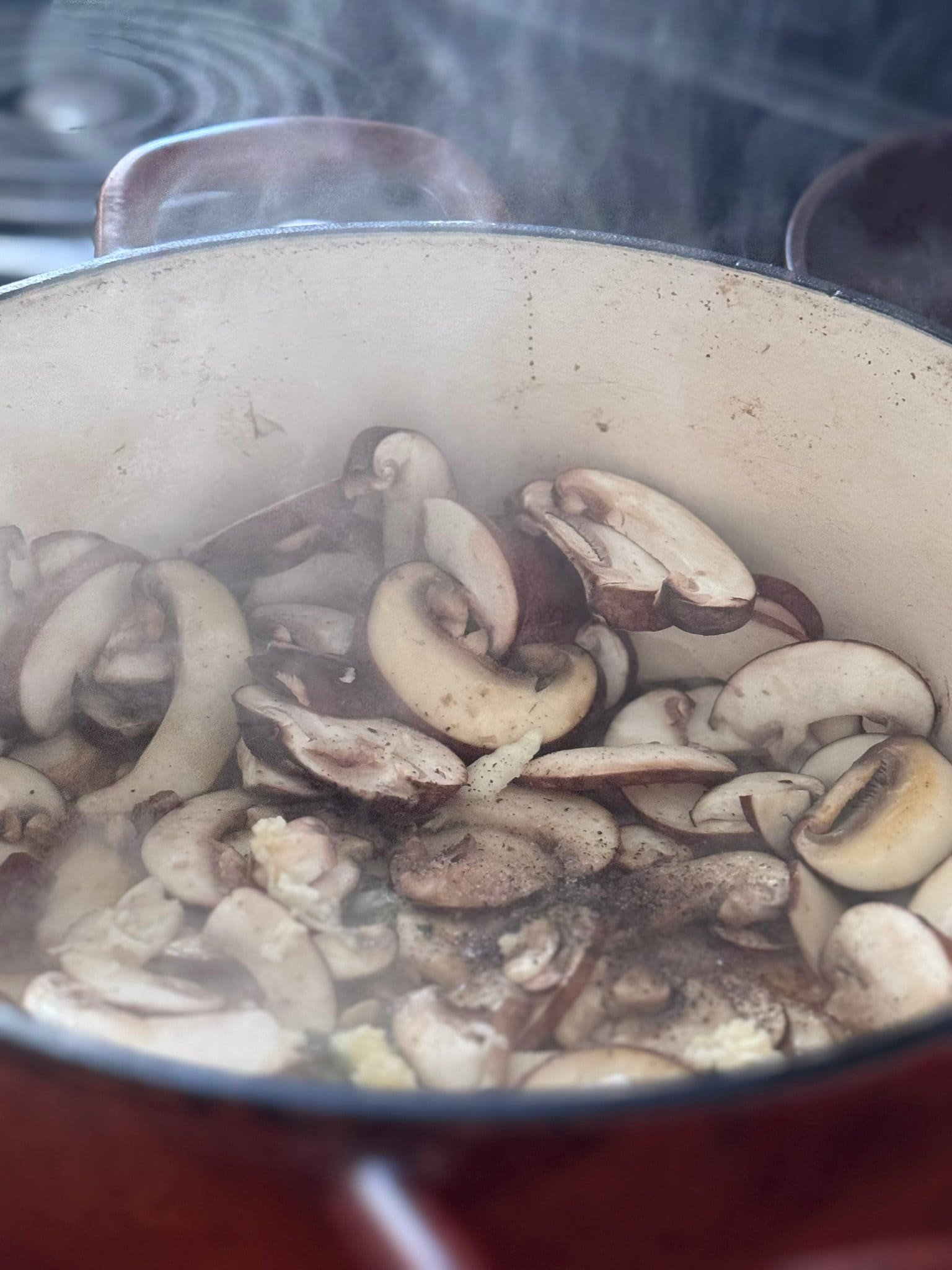 Creamy Mushroom Pasta cooking mushrooms in a dutch oven