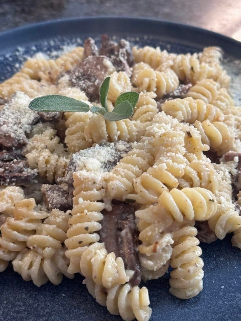 creamy mushroom pasta served with parmesan cheese on top