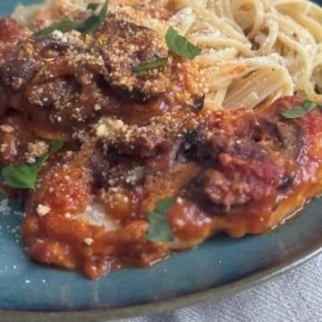chicken parmesan dish served on pasta