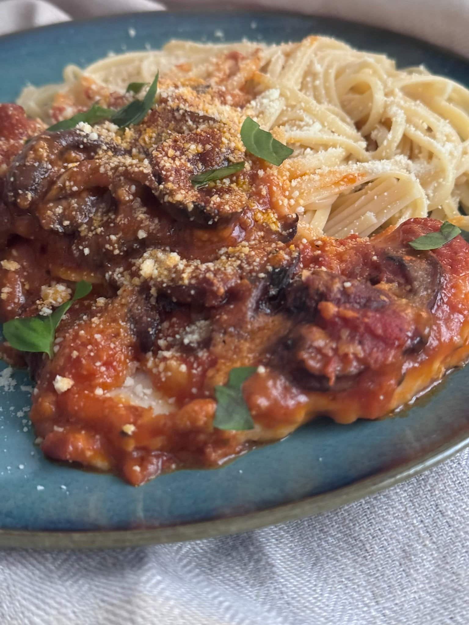 IMG_5644 chicken parmesan dish served on pasta