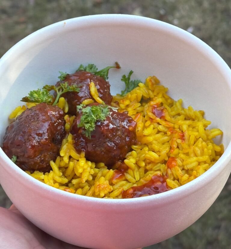 sweet and spicy meatballs on a yellow rice